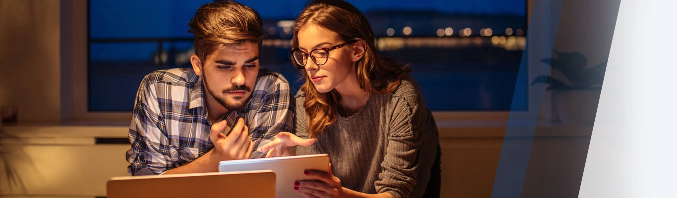 Young couple looking at mobile tablet