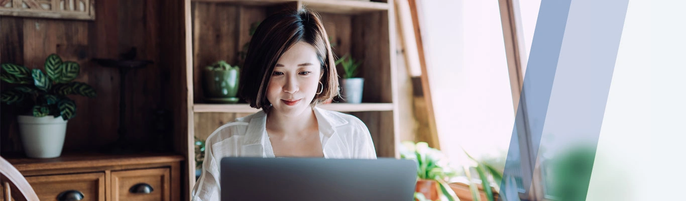 woman in dining room with laptop